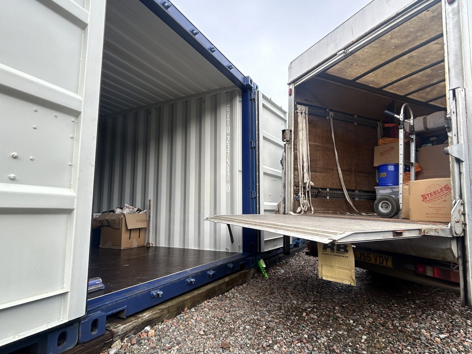 A van unloading into a shipping container easily