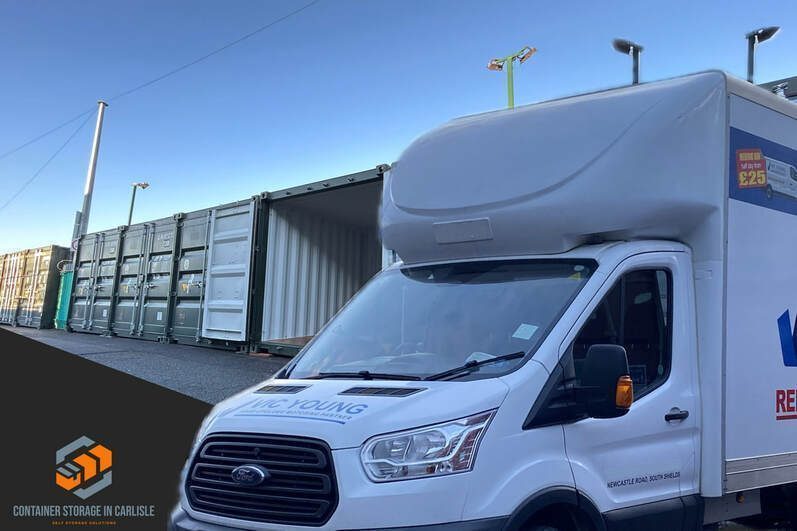 a row of shipping containers used for self storage purposes with a car unloading into one