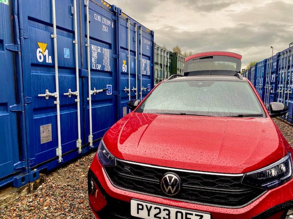 car parked outside a shipping container unit