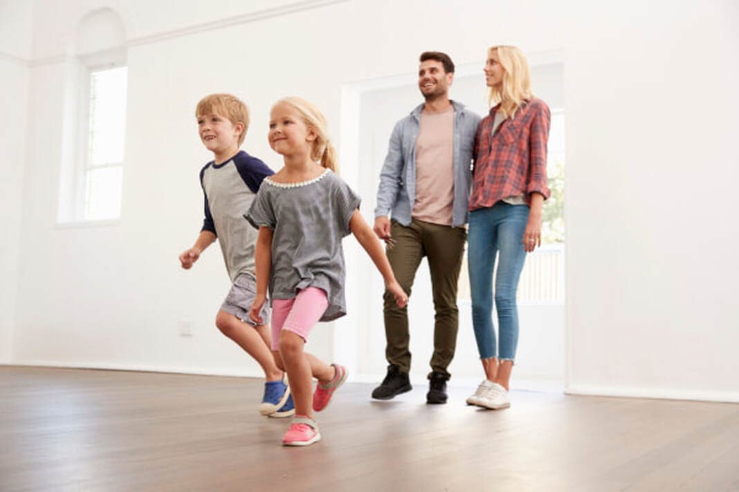 a happy family moving into their new home for the first time