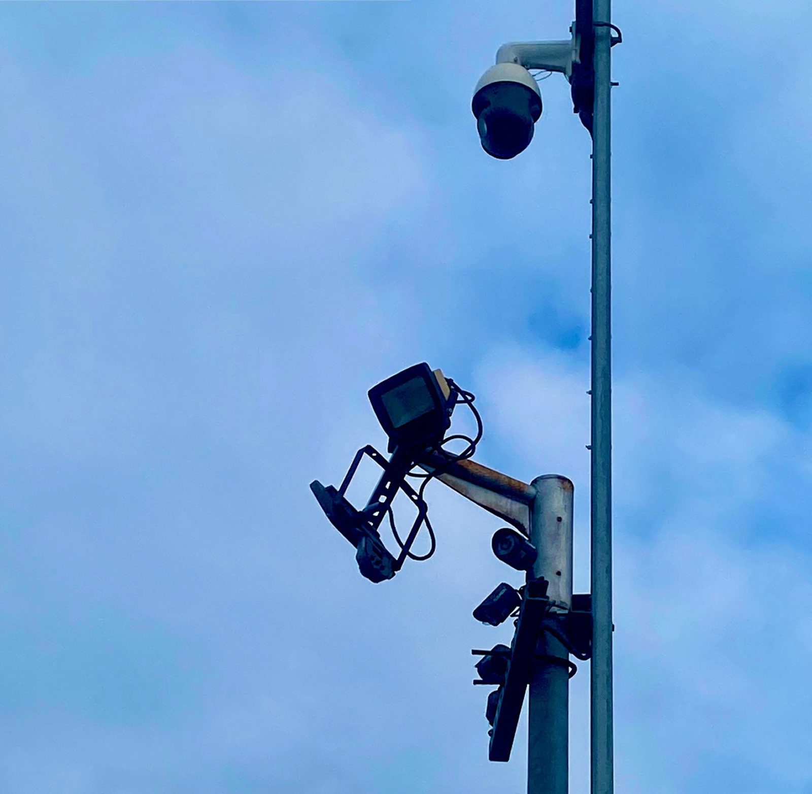 CCTV camera and floodlights mounted on a pole