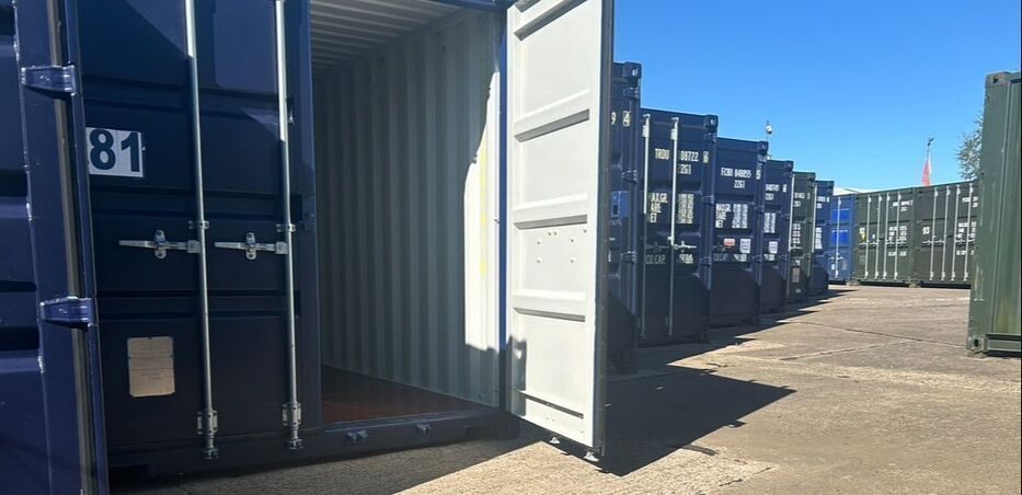 rows of shipping containers with a door open ready for loading