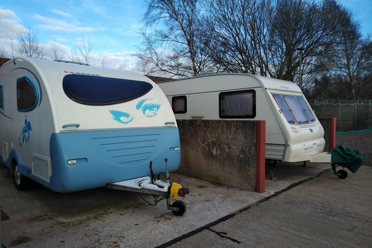 two caravans parked in their own bays on the storage yard