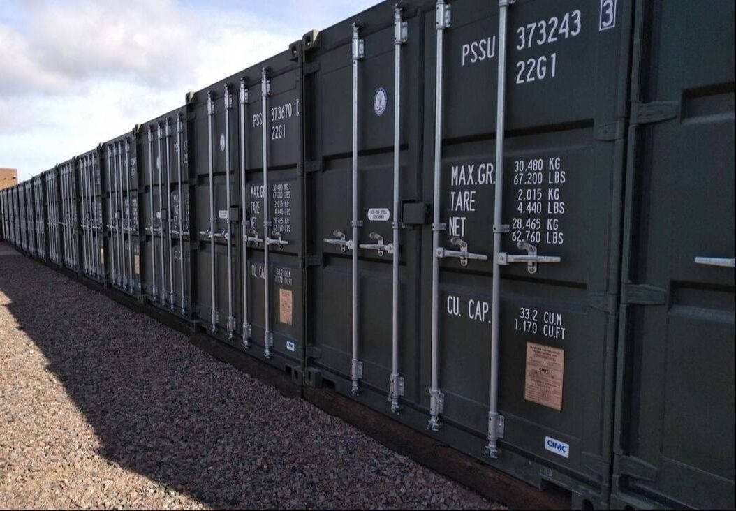 A row of shipping containers of varying sizes