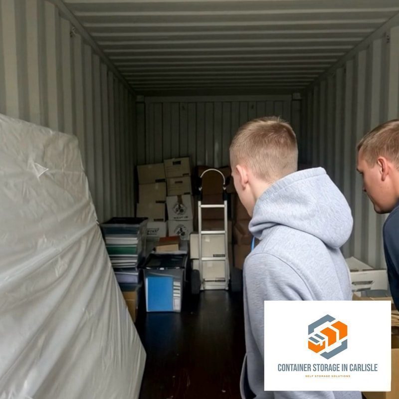 two people inspecting their contents inside a shipping container