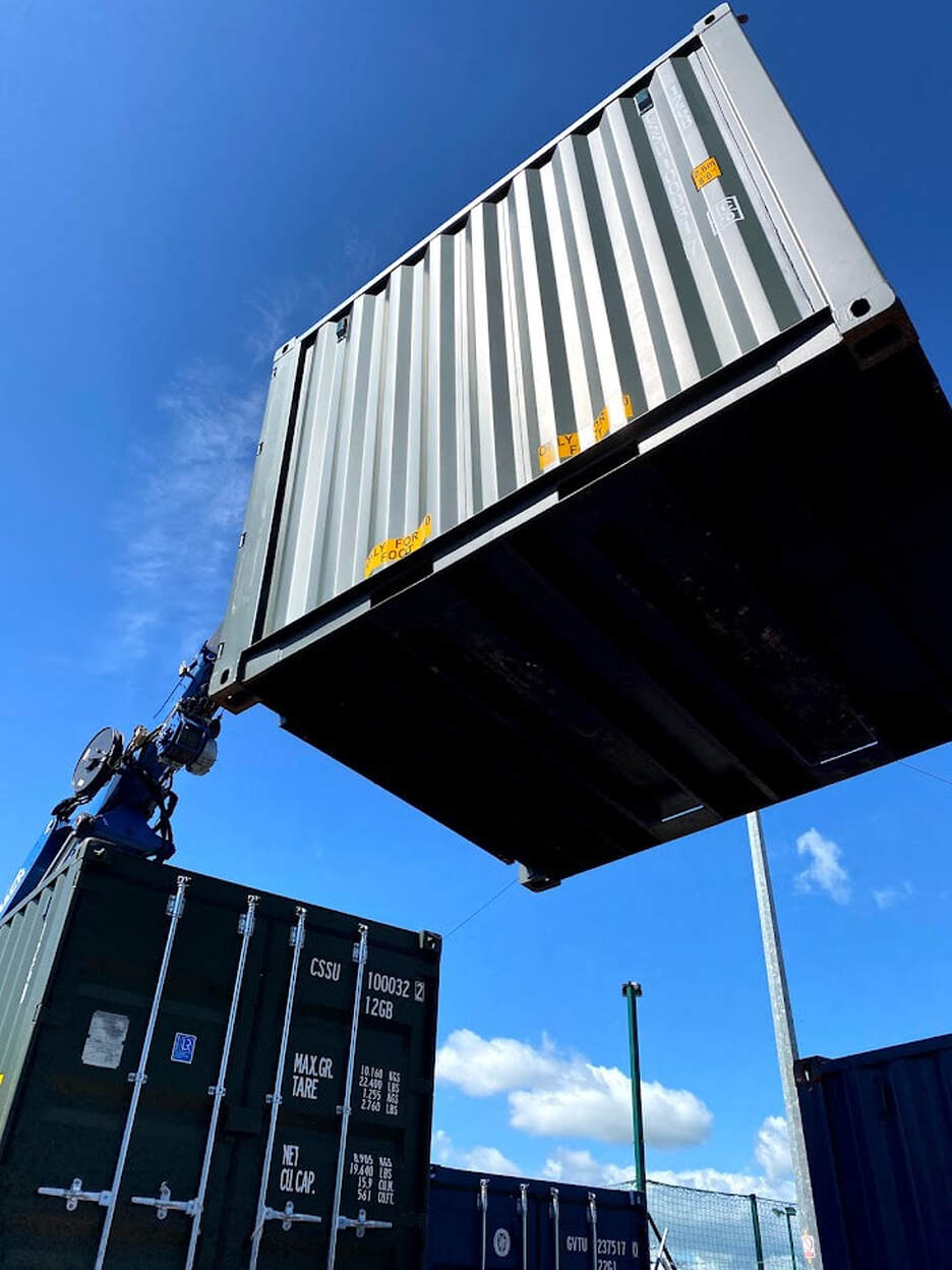 shipping container being sited on a storage depot