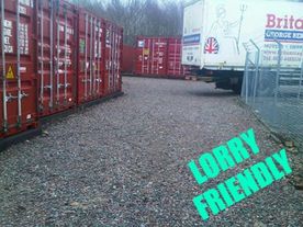 lorry beside shipping container