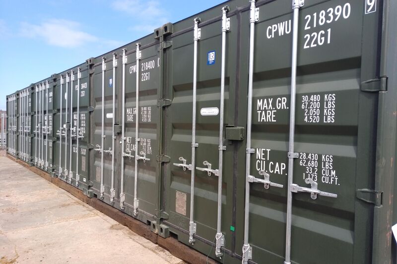 a row of green shipping containers
