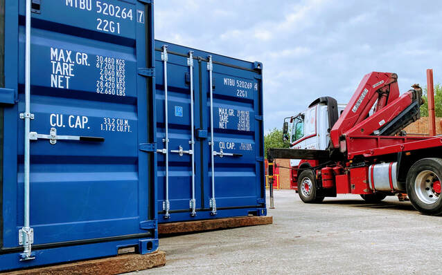 A Hiab unloading shipping containers